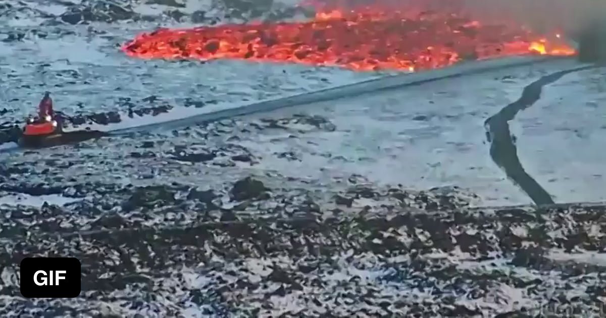 Icelandic worker trying to stop a tide of lava today