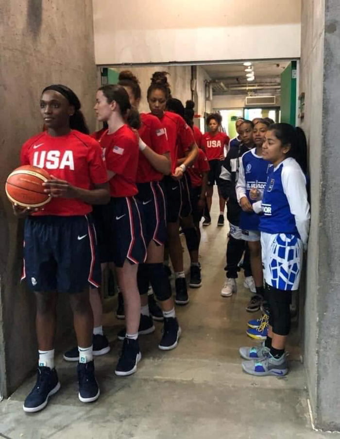 American U16 women's basketball team standing next to El Salvador's U16 team