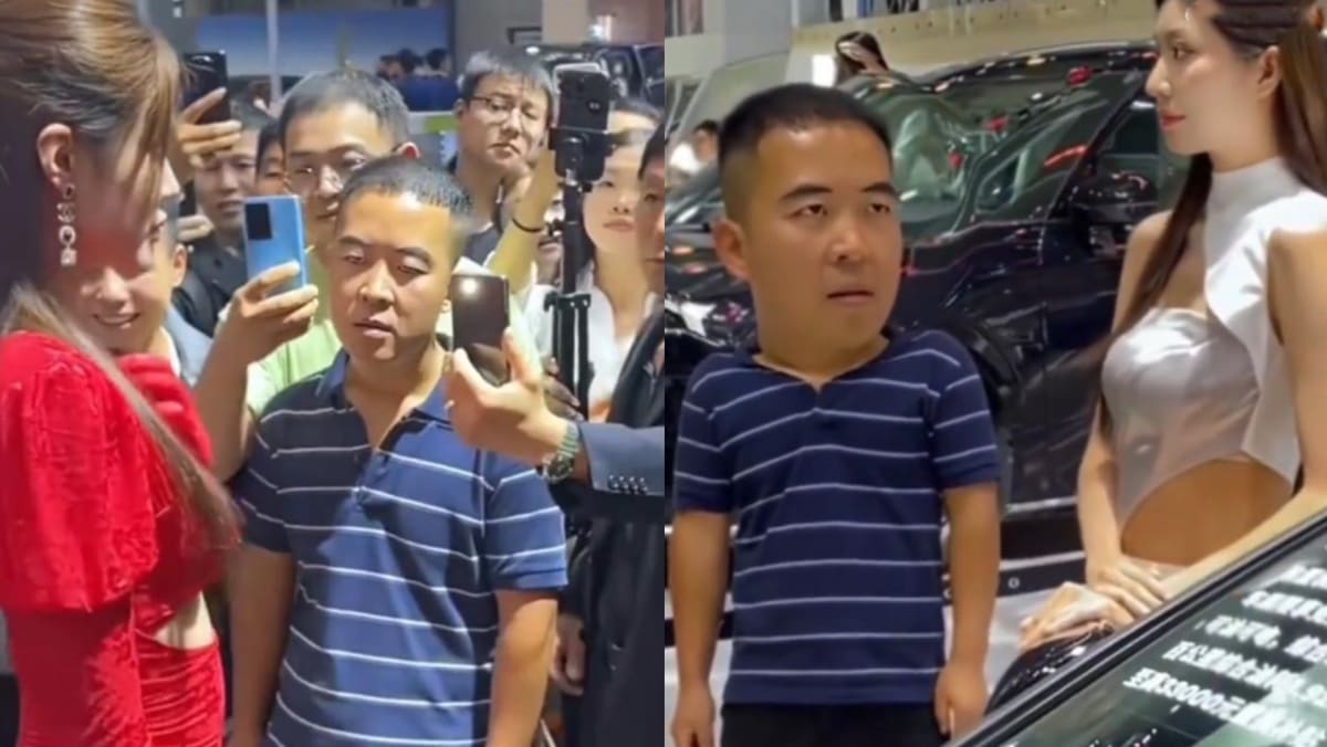 Striped Polo Shirt Uncle Stares At Car Show Models As If Under A Spell