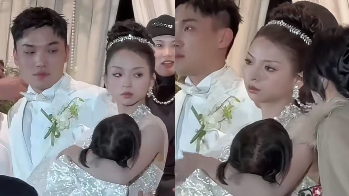 Bride Goes Viral For Looking Annoyed While Carrying Sleeping Daughter At Her Wedding